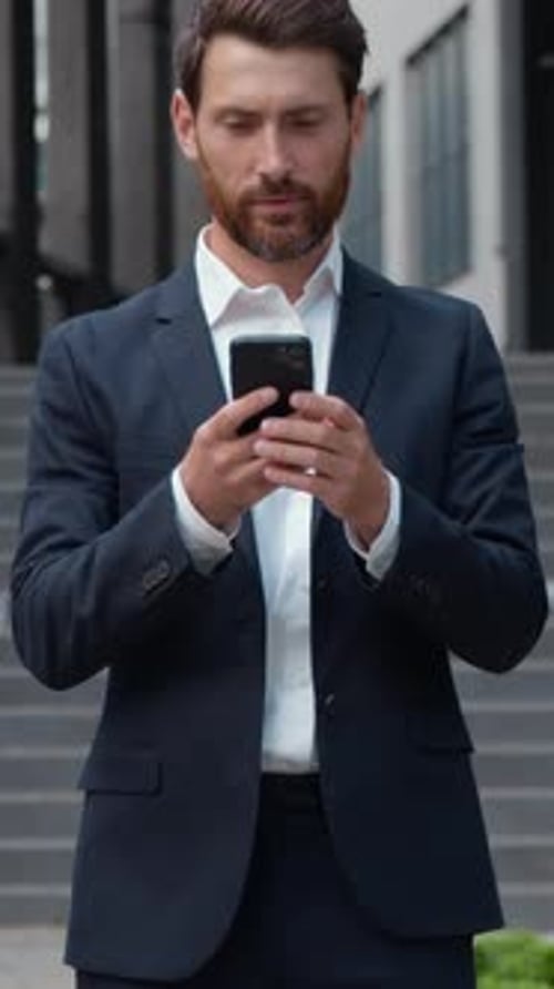 Caucasian Mature Successful Business Man in City Businessman with Phone Holding Smartphone Using