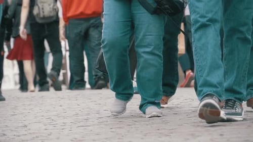 Füße von Menschenmengen, die in Zeitlupe auf der Straße laufen