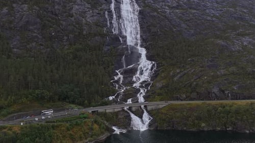 Aerial image of powerful Langfossen waterfall in lush Norwegian valley