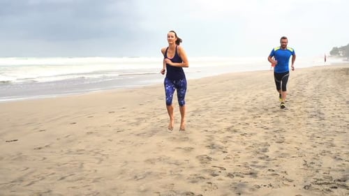 Sportive Couple Jogging On Beach, Super Slow Motion 240fps