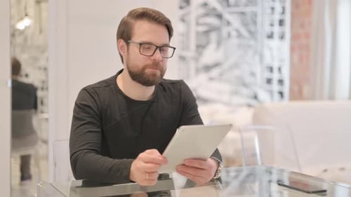 Man With Tablet Gestures Winning Indoors