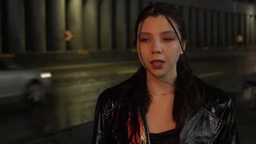 Young Woman in Black Jacket at Night