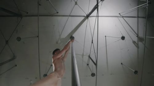 Bottom View of Man Pole Dancing in Studio