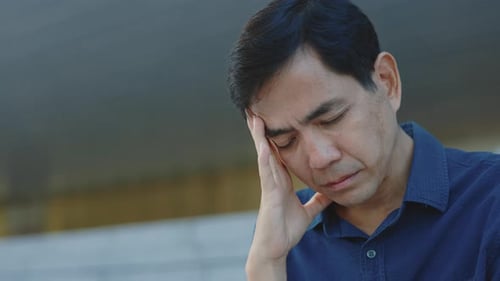 Man With Head in Hand Looking Sad