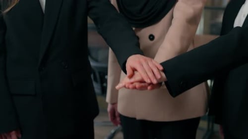 Businesswomen Stack Hands Then Applaud in Modern Office