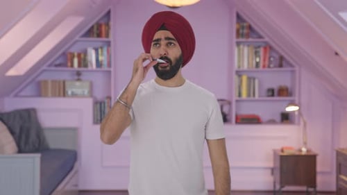 Sick Man Taking Temperature in Bedroom