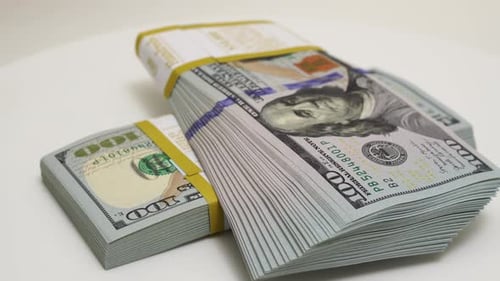 Stack of Bank Bundles with US Dollars on a White Background Closeup Shot of New Freshly Printed