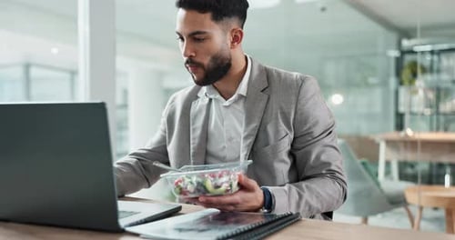 Man, eating and laptop at desk, typing and office with salad, technology and working lunch