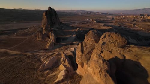 Cinematic FPV Flight Close to the Tops of Rocks in Cappadocia at Sunset