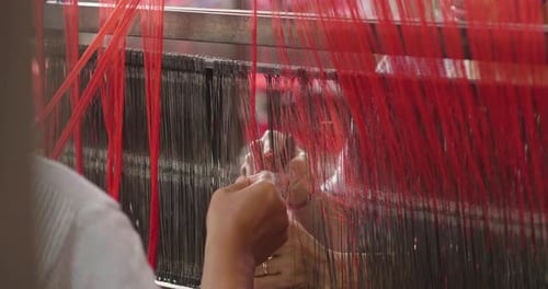 Close Up of a Person Weaving Fabric