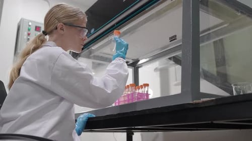 Young Woman Scientist Working with Test Tubes
