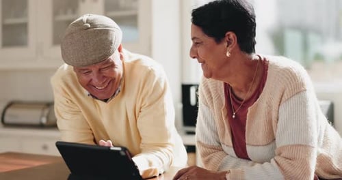 Senior Couple Sharing a Laugh in Kitchen