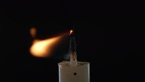 Lighting a Candle Wick in Dark Background Close Up