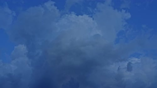 Golden Hour Clouds Move Across Deep Blue Sky