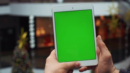 Man Using Vertical Tablet with Green Screen Closeup Shot of Man's Hands with Tablet Chroma Key Close