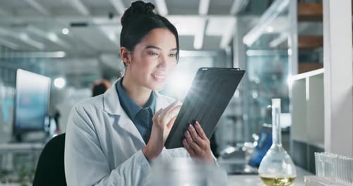 Woman Working on Tablet in Modern Laboratory