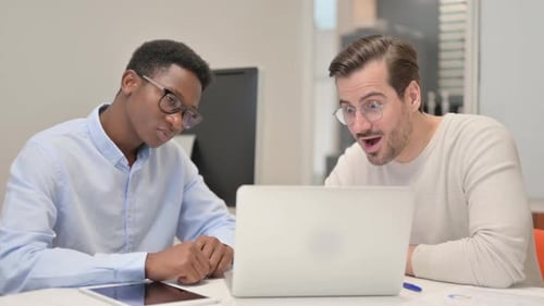 Excited Business People Celebrating Success in Office