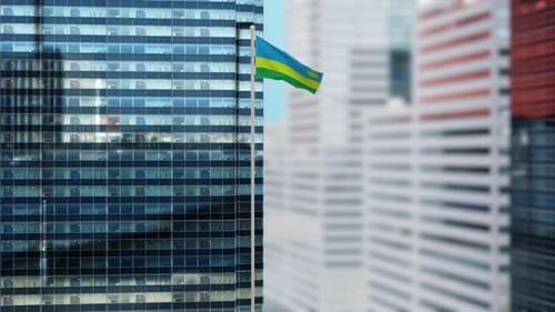 Rwanda Flag Waving on Modern Skyscraper Building