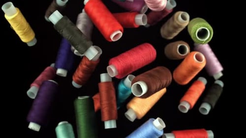 Multicolored Threads Fly on a Black Background Filmed on a Highspeed Camera at 1000 Fps