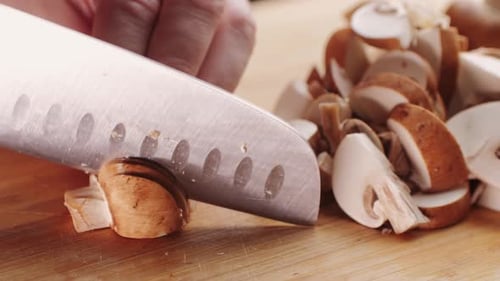 Chef Cutting the Mushrooms on a Wooden Board with Knife Mushroom Cooking Close Up