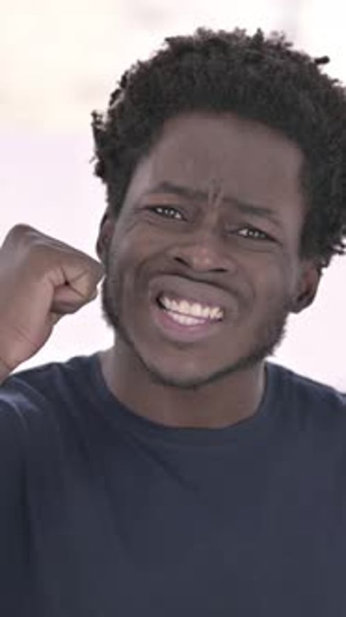 Portrait of African Man getting Angry in Office, vertical video