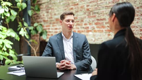 Business Meeting Handshake Businessman and Businesswoman Closing a Deal in a Modern Office