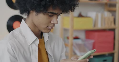 Young Adult Using Smartphone Indoors