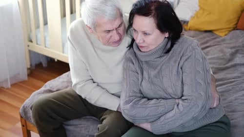 Loving Senior Couple Embrace in Comfortable Home Setting