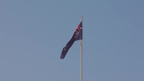 Australian Flag Waving in Wind on Blue Sky