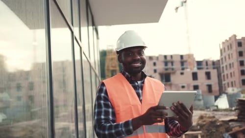 Construction Worker Using Tablet at Building Site