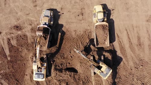 Aerial View of Excavators Loading Dump Trucks