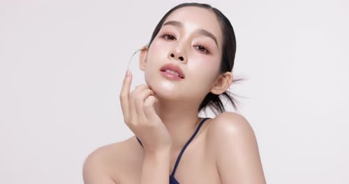 Slow motion of beautiful young Asian girl with k-beauty make up style.