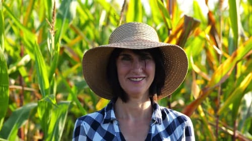 Happy Smiling Female Farmer Looks Into Camera Standing Near Corn Field Portrait of Adult Beautiful