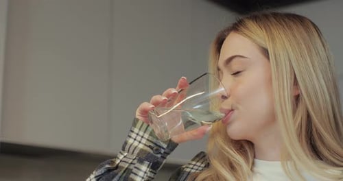 Close Up Attractive Girl Drinking Water on Domestic Kitchen Health and Diet Concept
