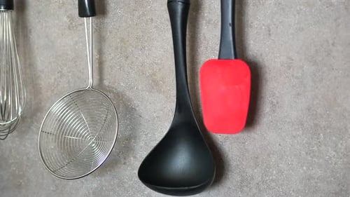 Organized Kitchen Utensils Hanging on Wall