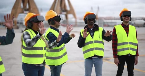 Multiracial Workers Using Virtual Reality Headsets At Industrial Terminal Port