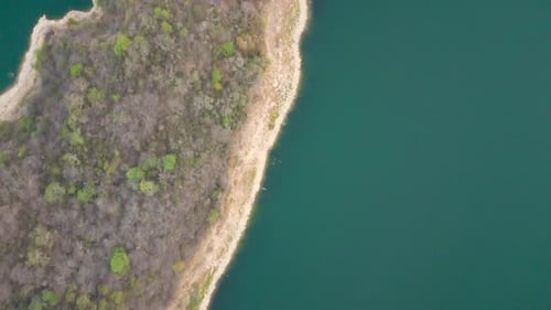 Aerial drone flying over a lake, water dam, with mountains at sunrise. Beautifull dreamy landscape
