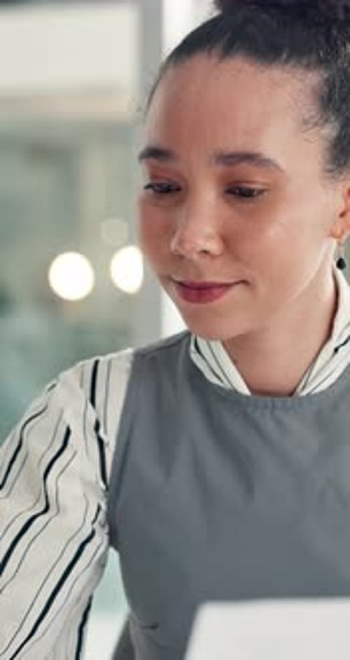 Paper, reading and typing with business woman in office for report or review of information