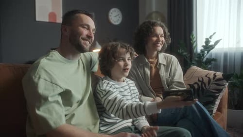 Family Watching Television Together at Home