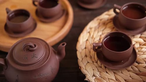 Cerimônia do chá: utensílio de chá asiático tradicional que serve um conjunto autêntico, pessoa servindo chá marrom