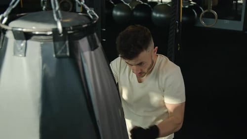Top View Caucasian Boxer Champion MMA Professional Fighter Man Boxing Punch Bag in Sport Club Male