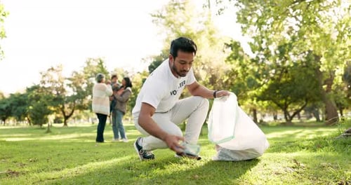 Cleaning, volunteer and man in park with litter for community service, recycling and sustainability