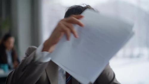 Dissatisfied Ceo Arguing Cellphone Call Sitting Office with Documents Closeup