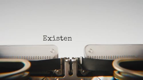 Old mechanical typewriter typing Existential Thoughts in a close-up view.