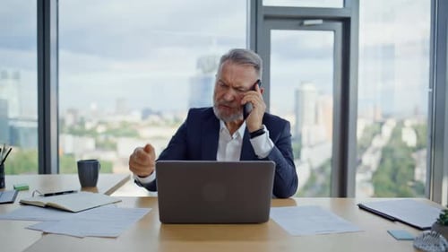 Frustrated Businessman Arguing on Phone in Office