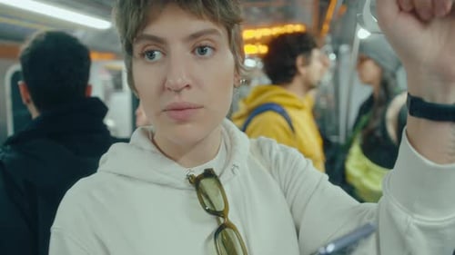 Woman Using Phone in Subway Train during the Ride
