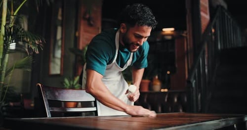 Wipe, man or waiter in cafe, cloth or cleaning with maintenance, hospitality or friendly service