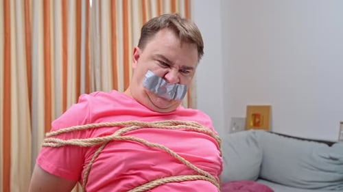 Man bound desperately strives to break free from confinement