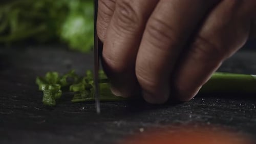 Fresh Green Onions Being Chopped on Black Cutting Board, Static Shot