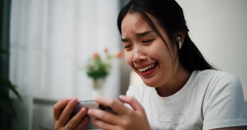 Emotional Woman Reacts to Smartphone Mobile Game